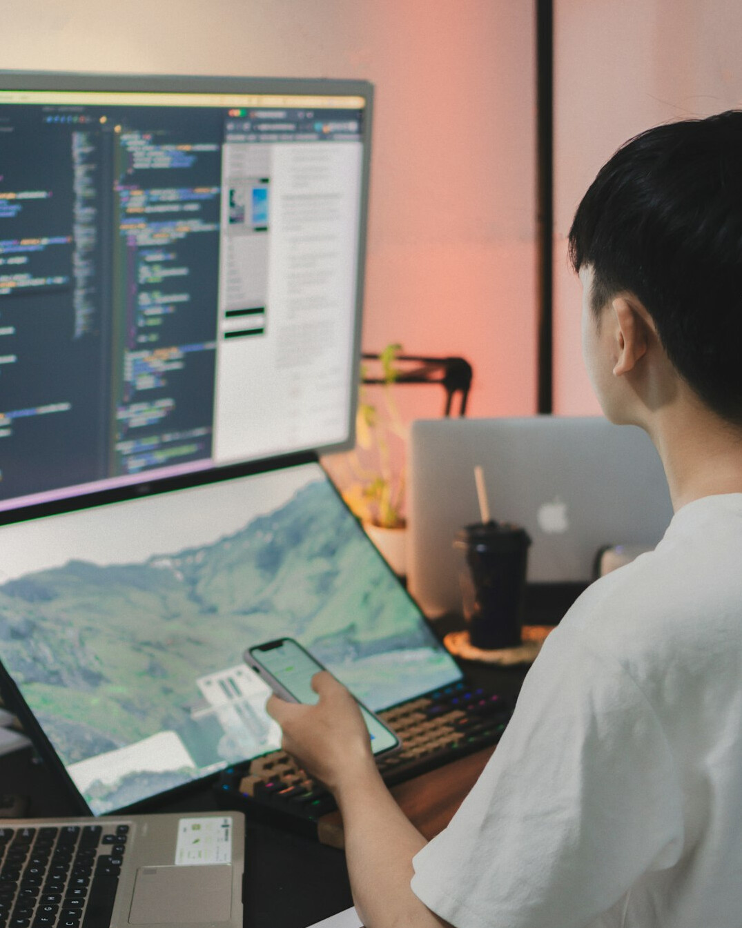 young man coding on computer
